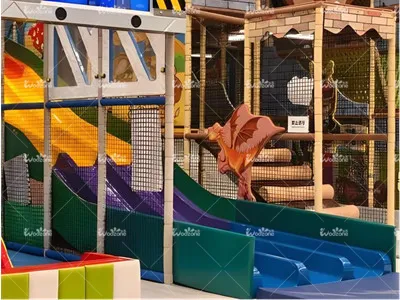 Colorful indoor playground structure with multiple slides, climbing nets, and activity areas, designed for children's fun and exercise.