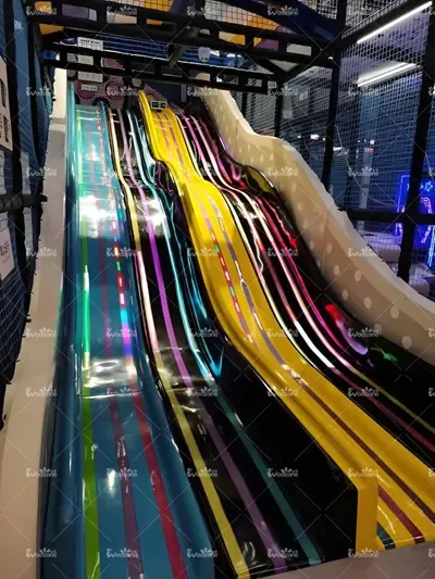Vibrant multi-lane rainbow racing slide, commercial indoor kids playground high-speed plastic slide for family entertainment center