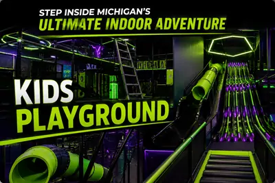 Commercial indoor kids playground equipment featuring multi-lane wave slides and tube slides at Summit Ninja Challenge family entertainment center.