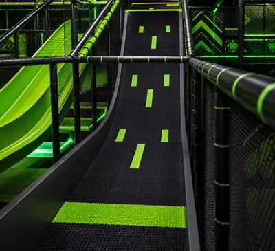 An indoor adventure park free fall slide designed and manufactured by Woozone Playground, featuring professional indoor amusement equipment.